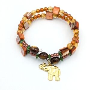 Beaded wire bracelet with gold tone elephant charm
